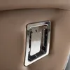 A close-up shot of a chrome handle on a brown leather-like surface. Produktbild-Vorschau