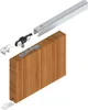 A sliding door hardware set is shown, including a track, rollers, and mounting brackets, alongside a section of a wooden door. Produktbild-Vorschau
