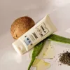 A product shot of a hair mask tube with natural ingredients like coconut and aloe vera. Náhled obrázku produktu