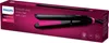 The image shows the packaging of a Philips hair straightener. The packaging is dark pink and features a picture of the black and pink hair straightener. Voir les images du produit