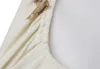 A close-up view of a cream-colored fabric with a teddy bear pattern and elasticated edge. Produktbild-Vorschau