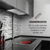 A modern kitchen scene featuring a built-in extractor hood above a stovetop. Náhľad obrázku produktu