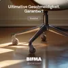 Close-up of the base of an office chair with wheels on a wooden floor. Podgląd zdjęcia produktu