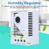A white humidity regulator with a dial and ventilation slots, set against a light blue and white background with green leaf graphics. Anteprima dell’immagine prodotto