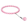 A pink hula hoop with a weighted ball attached by a string, isolated on a white background. Podgląd zdjęcia produktu