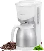 A white and silver coffee maker with a carafe, placed next to a pile of coffee beans and a sprig of mint. Anteprima dell’immagine prodotto