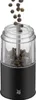 A pepper grinder with peppercorns falling into it. Produktbild-Vorschau