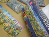A large jigsaw puzzle box and some of the puzzle pieces are laid out on a table. Produktbild-Vorschau