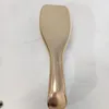 A gold hairbrush is shown on a marble-like surface. Anteprima dell’immagine prodotto