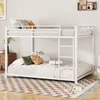 A white metal bunk bed with mattresses and pillows in a bedroom setting. Anteprima dell’immagine prodotto