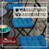Outdoor cafe setting with blue seat cushions on chairs and a cup of coffee on a table. Produktbild-Vorschau