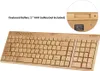 A close-up view of a bamboo keyboard and a circular inset showing the battery compartment and product information. Produktbild-Vorschau