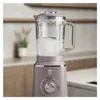A taupe stand mixer with a glass pitcher filled with ice and water, shown in a kitchen setting. Voir les images du produit