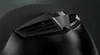 A close-up view of the top ventilation system of a black helmet. Voir les images du produit