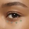 A close-up shot of a person's eye area with several drops of eye gel applied to the under-eye area. Anteprima dell’immagine prodotto