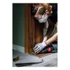 A person is using a sander on a wooden door frame. Voir les images du produit