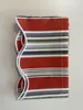 A folded striped awning valance on a light gray surface. Produktbild-Vorschau