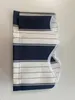 A folded awning valance with navy and white stripes. Produktbild-Vorschau