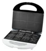 An open waffle maker with decorative plates. Produktbild-Vorschau
