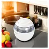 An ice cream maker sits on a kitchen counter next to a bowl of fruit. Náhľad obrázku produktu