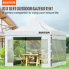 A white gazebo tent set up in a grassy yard with a table and chairs inside. Voir les images du produit