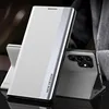 A white and silver phone case is displayed on a dark surface. Anteprima dell’immagine prodotto