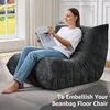 A woman is sitting on a large beanbag chair reading a book in a well-lit room. Produktbild-Vorschau