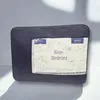 A dark blue fabric bag containing a duvet with a label showing stars and text. Produktbild-Vorschau