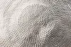 A close-up of a textured metallic surface with a hammered pattern. Produktbild-Vorschau