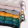 A stack of colorful cushions in various shades. Náhled obrázku produktu
