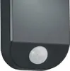 A close-up of a black motion sensor with a white sensor lens. Náhled obrázku produktu