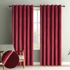 A pair of red velvet curtains hanging in front of a window, with a close-up inset showing the fabric texture.