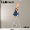 A young child stands on a stepladder reaching for a smoke detector on the ceiling. Produktbild-Vorschau