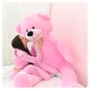 A woman kissing a giant pink teddy bear. Anteprima dell’immagine prodotto