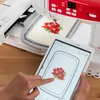 A person is using a tablet to control a sewing and embroidery machine. Produktbild-Vorschau