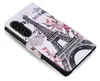 A flip-style phone case with a design of the Eiffel Tower and flowers. Produktbild-Vorschau