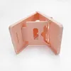 A pink plastic accessory for the Nintendo Switch, shown from a diagonal angle against a white background. Produktbild-Vorschau