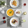 A beautifully set dining table with multiple courses and place settings. Produktbild-Vorschau