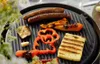 Food being grilled on an outdoor grill. Podgląd zdjęcia produktu