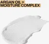 A swatch of white conditioner with textured lines, with text overlay indicating "ARGAN OIL + MOISTURE COMPLEX". Voir les images du produit
