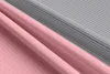 A close-up view of folded fabric with alternating pink and gray stripes. Produktbild-Vorschau