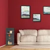 A corner of a living room with a red wall, a white sofa, and a dark gray corner shelf unit. Produktbild-Vorschau
