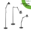 Three black floor lamps of varying heights and positions against a white background. Produktbild-Vorschau