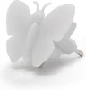 A white butterfly-shaped night light plugged into an outlet. Produktbild-Vorschau