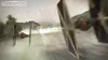 Two TIE fighters flying through a misty, green landscape, with one firing a laser. Produktbild-Vorschau