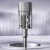 A transparent cylindrical container with spices inside, attached to a silver handle, against a backdrop of vertical white panels and a reflective surface. Produktbild-Vorschau