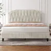 A beige upholstered bed with a tufted headboard is shown in a bedroom setting. Podgląd zdjęcia produktu