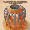 A close-up studio shot of an orange and gray scalp massager. Produktbild-Vorschau