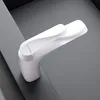 A white faucet is shown on a gray surface. Anteprima dell’immagine prodotto