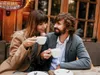 A couple enjoying coffee on a patio with an outdoor heater. Podgląd zdjęcia produktu
